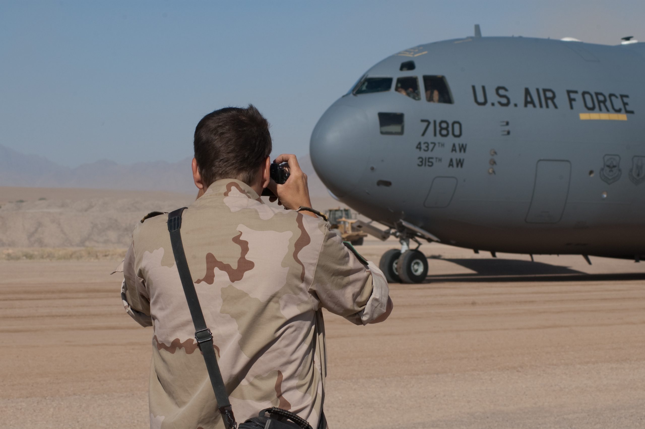 militair taking picture of cargo plane u.s. air force